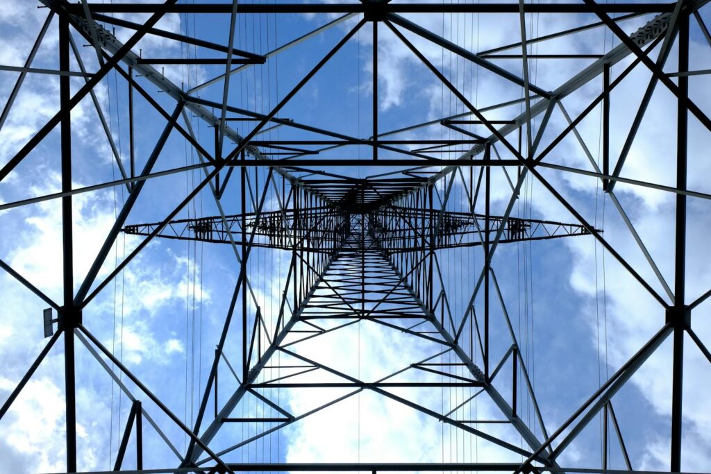 Philippines Power Market Model 3 Looking up at a steel power pylon against a bright blue sky.