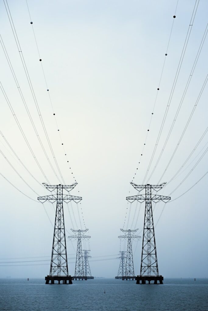 Consulting 1 A couple of power lines sitting over a body of water